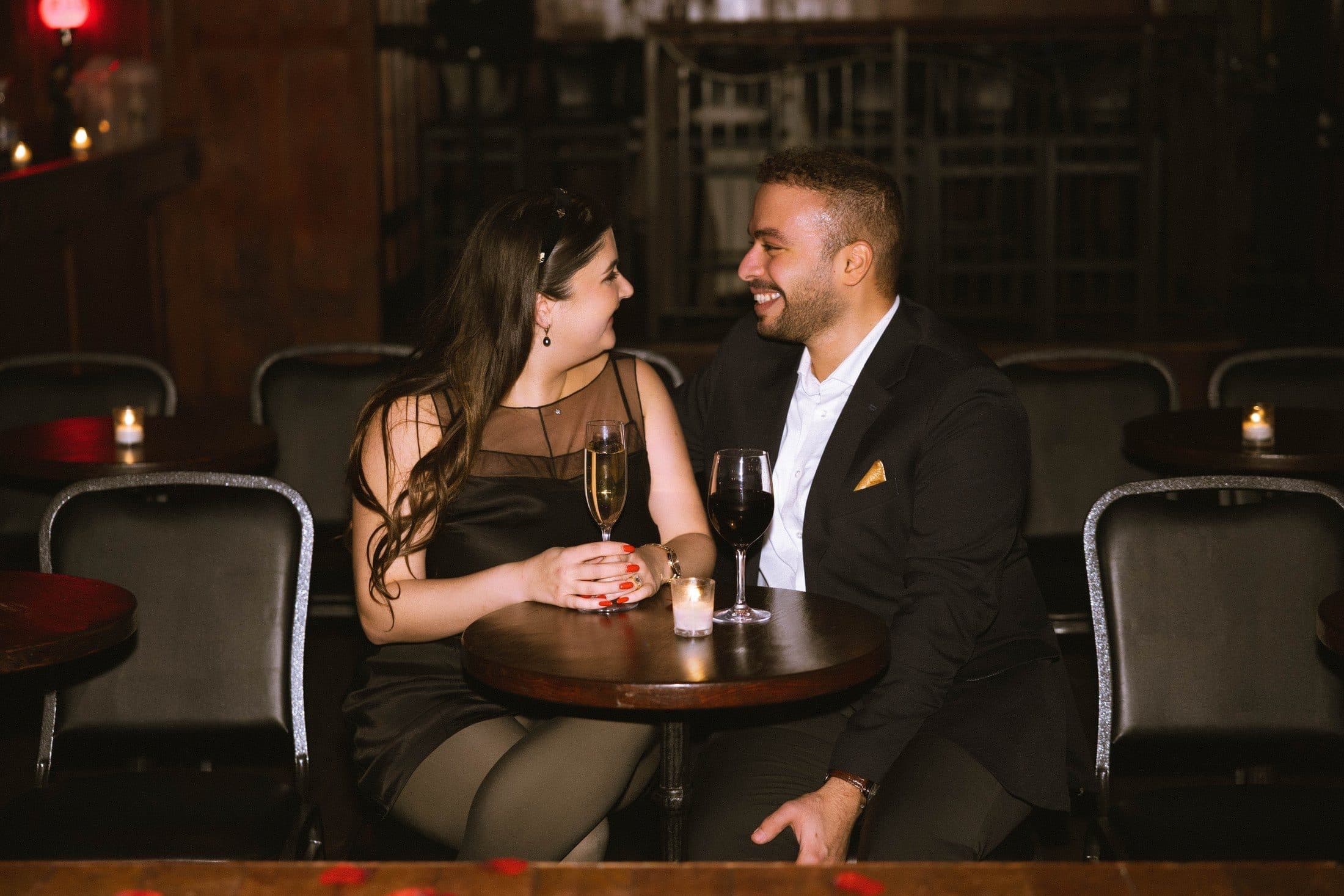 Rodolf and Lexie sitting together at a candlelit table